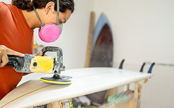 Person crafting a surfboard
