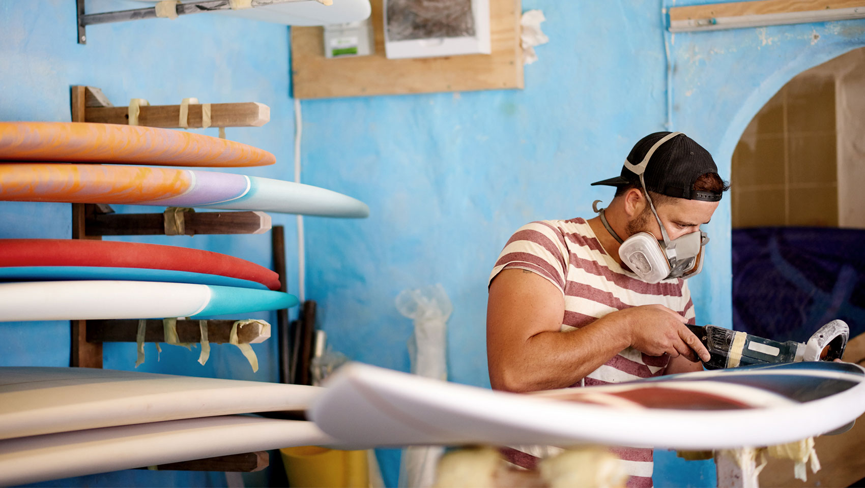 man working on surfboards