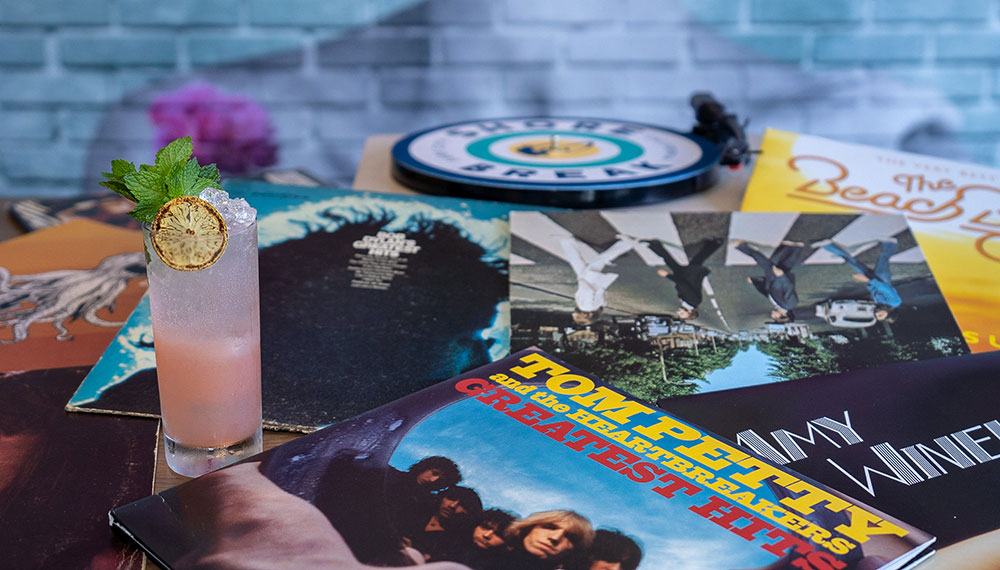 Image of cocktail and records on a table