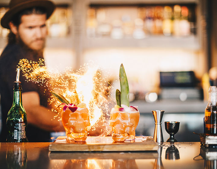 bartender preparing cocktails with flames