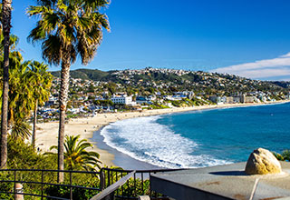 beach view with homes in the background on a hill