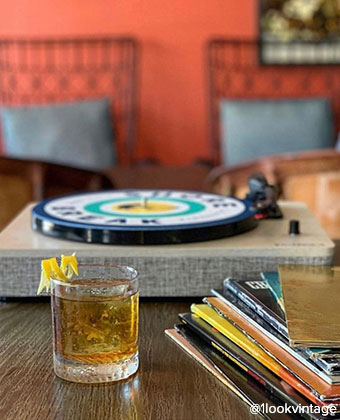 turntable, records, and a cocktail