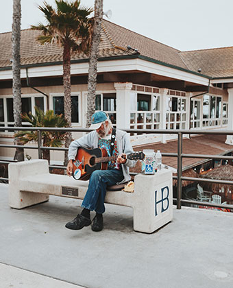 Man playing guitar on bench