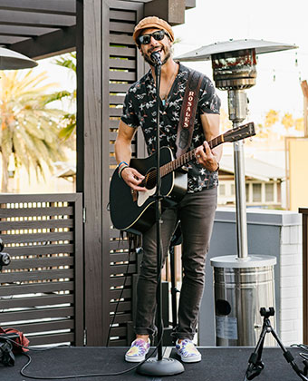 musician playing guitar on stage