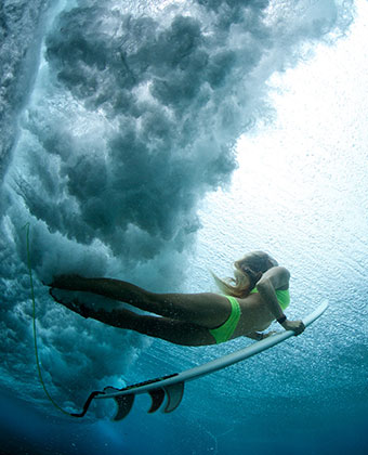Girl underwater with Surfboard
