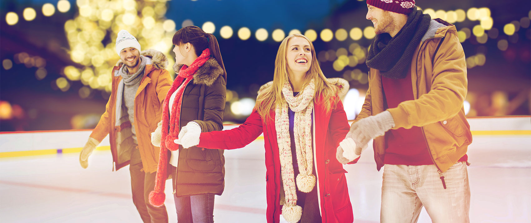 Two Couples Skating at an Ice Rink